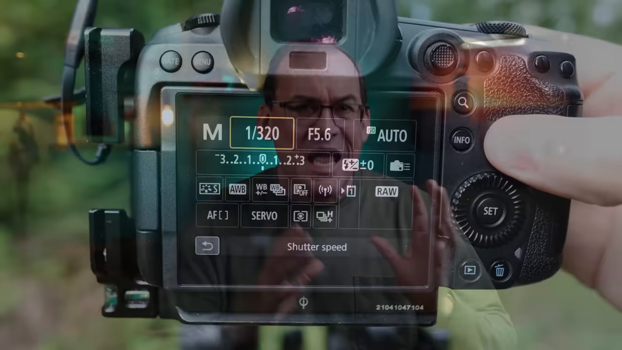 [09:55] A close-up demonstration of a Canon camera's LCD screen, showing the user navigating the menu to set the camera to Manual mode with Auto ISO.