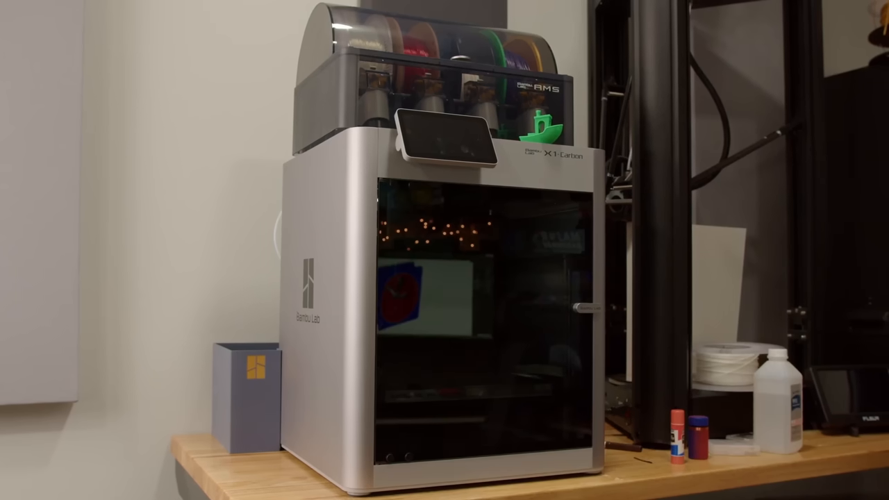 Footage of the Bambu Lab X1 Carbon 3D printer sitting on a desk.